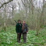 Two people standing in woodland in springtime